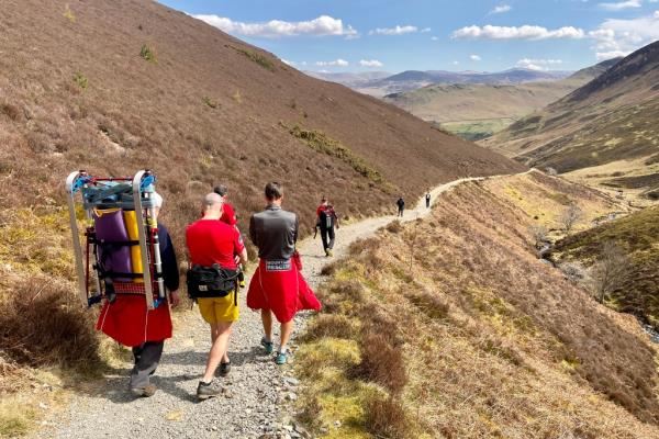 The group of men are escorted off the mountain.