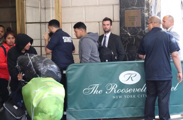 Detectives investigate outside the Roosevelt Hotel, after a migrant allegedly assaulted a hotel worker.