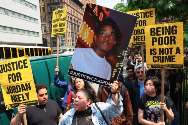 Protestors holding up signs demanding justice for Jordan. 