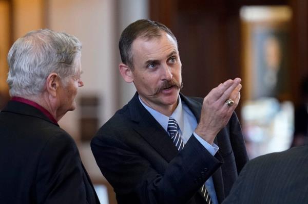 Texas State Rep. Andrew Murr, R-Kerrville, right, talks with fellow lawmakers in the House Chamber at the Texas Capitol, Monday, Aug. 23, 2021, in Austin, Texas. 
