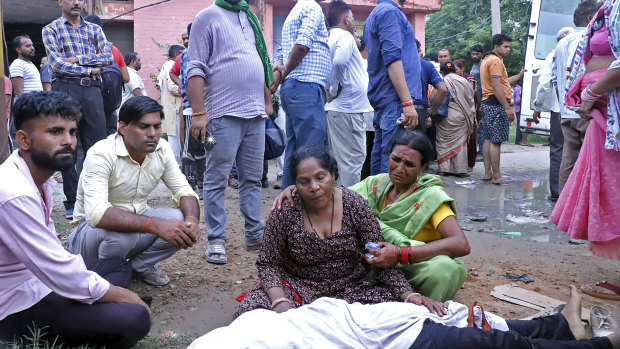 Women mourn next to the body of a relative outside the Sikandrarao hospital in Hathras district a<em></em>bout 350 kilometres southwest of Lucknow, India.