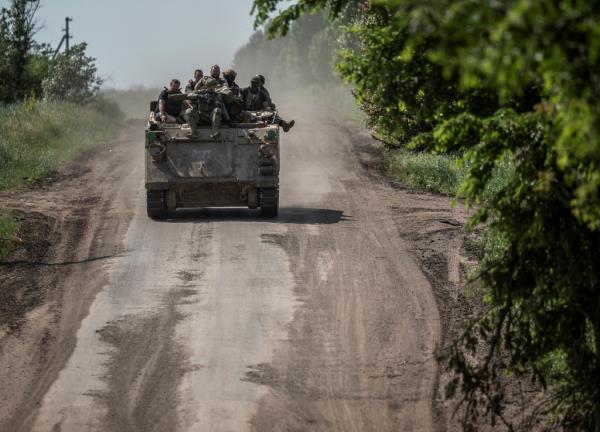 Ukrainian soldiers ride a BMP-1 infantry fighting vehicle, amid Russia's attack on Ukraine, near the front line city of Bakhmut on Friday. 
