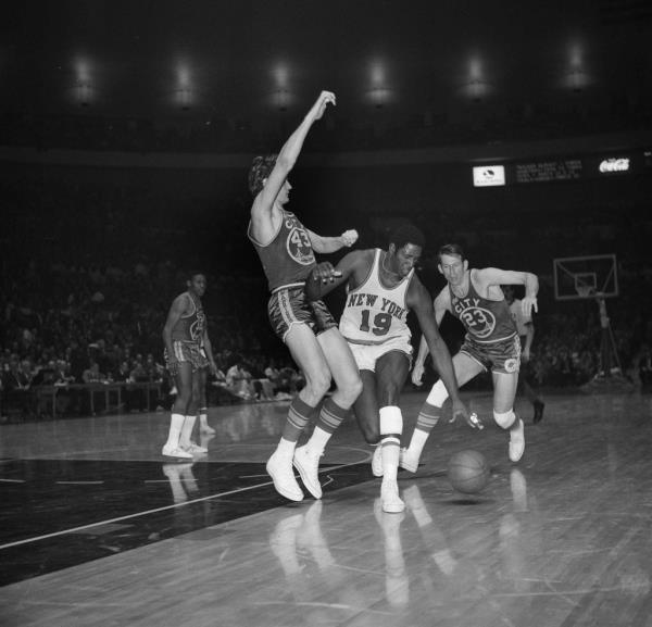 Willis Reed (19) drives against San Francisco Warrior Clyde Lee (43) during an NBA game at Madison Square Garden in New York, March 4, 1970