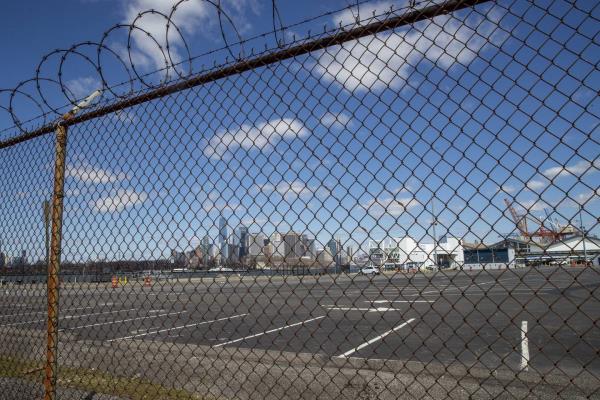 FILE - The Manhattan skyline is seen behind the parking lot and terminal of the Brooklyn Cruise Terminal on April 2, 2020, in New York. 