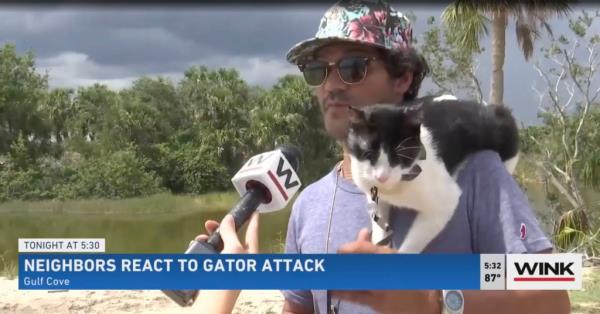 Manny Hidalgo interviewed by WINK News with Mr. Tom the cat on his shoulder.