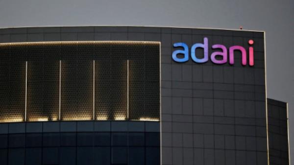The logo of the Adani Group is seen on the facade of one of its buildings on the outskirts of Ahmedabad, India, April 13, 2021. REUTERS/Amit Dave/