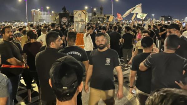 Protesters gather in Baghdad's Tahrir Square, carrying Iraqi flags and images of influential Iraqi Shiite cleric and political leader Muqtada al-Sadr, Saturday, July 22, 2023, following reports of the burning of a Quran carried out by a ultranatio<em></em>nalist group in front of the Iraqi Embassy in Copenhagen. Protesters attempted to cross the Jumhuriya bridge leading to the Green Zone, wher<em></em>e the Danish embassy is, but were pushed back by security forces. (AP Photo/Ali Jabar)
