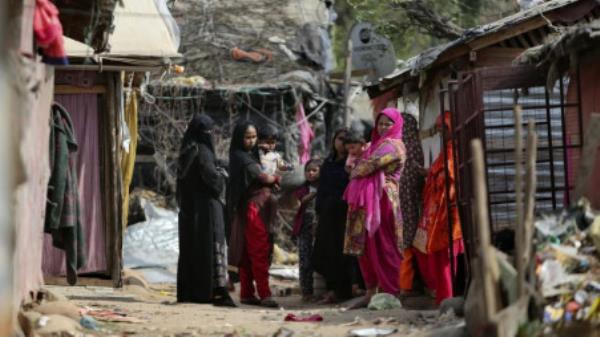 Rohingya refugees stand outside their makeshift camps on the outskirts of Jammu, India in March 2021. Rohingya women refugees are easy targets for exploitation and human trafficking.</p>

<p>　　Photo: AP