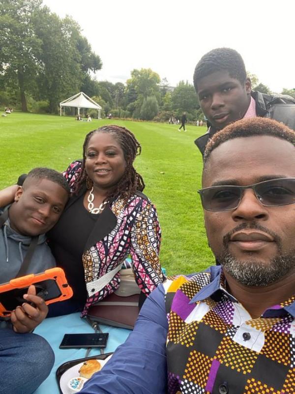 Anthony and Abi with both sons, in a park havin<em></em>g a picnic