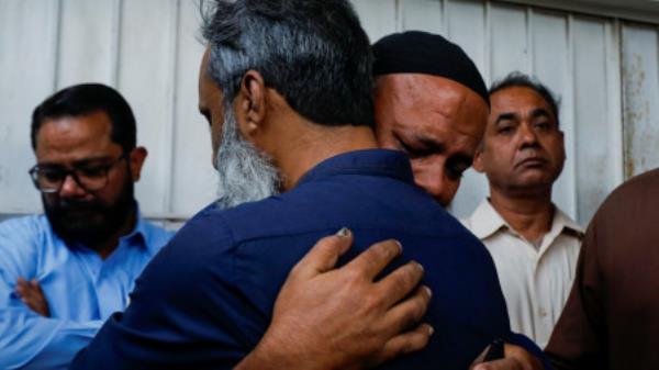 Relatives comfort each other as they mourn the death of a family member, who was killed, after a fire broke out at a multi-story shopping mall, at hospital morgue in Karachi, Pakistan November 25, 2023. REUTERS/Akhtar Soomro</p>

<p>　　