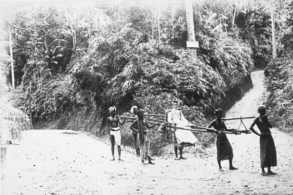 A European lady being carried up the hill on a sedan chair by doolie-carriers, circa 1895. Photo: Natio<em></em>naal Museum van Wereldculturen Leiden