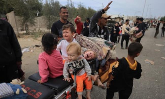 Displaced Palestinians arrive in a safer zone south of Gaza City on 12 November.