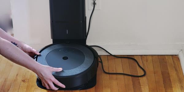 Person emptying Roomba dustbin