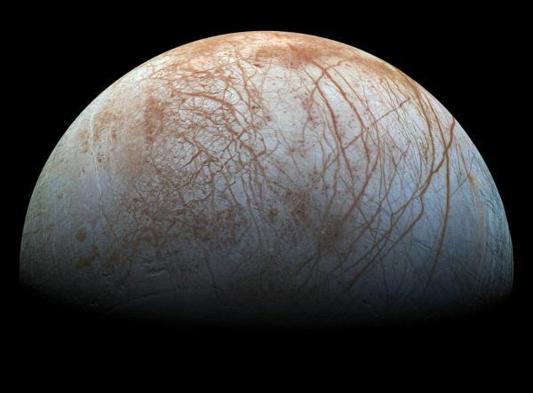 A grey round moon with rusty red streaks.