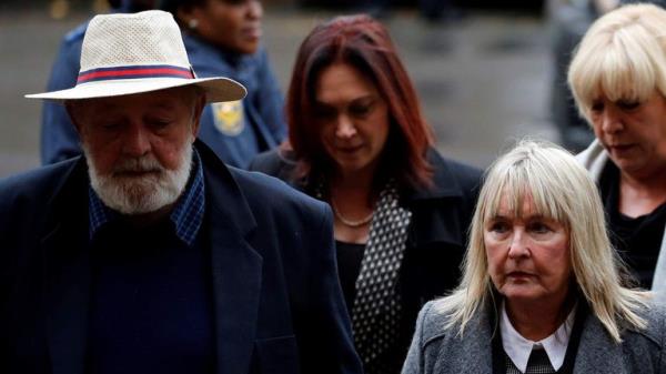Barry Steenkamp, father of Reeva Steenkamp, arrives with his wife June Steenkamp for the sentencing of former Paralympian Oscar Pistorius at the Pretoria High Court