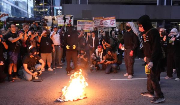 Protesters burn a flag near the Israeli Co<em></em>nsulate during the Democratic Natio<em></em>nal Co<em></em>nvention Tuesday, Aug. 20, 2024, in Chicago. (AP)