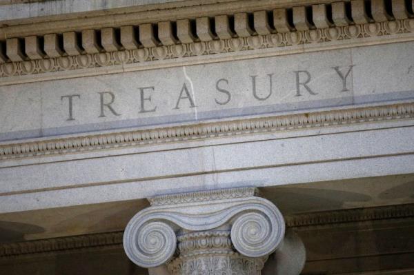 FILE- This June 6, 2019, file photo shows the U.S. Treasury Department building at dusk in Washington. The Treasury Department says it will employ extraordinary measures to avoid an unprecedented default on the natio<em></em>nal debt this summer, but officials say those measures could be exhausted “much more quickly” than normal given the unusual circumstances of the global pandemic. (AP Photo/Patrick Semansky, File)