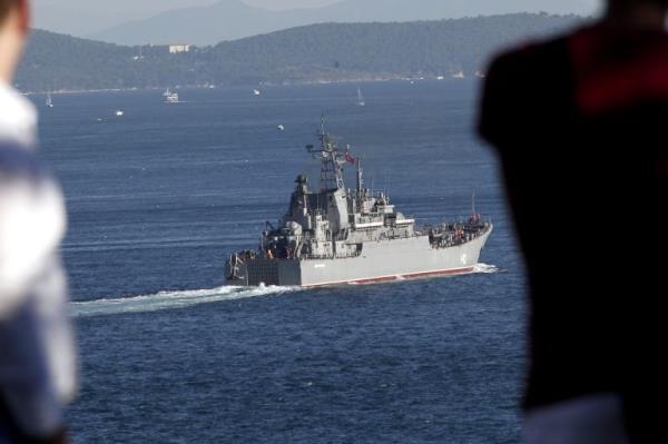 The Novocherkassk passing through the Bosphorus Strait before the war in Ukraine. Two men are watching from the hillside