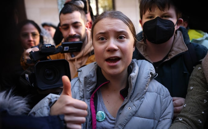 Swedish enviro<em></em>nmental activist Greta Thunberg gestures as she arrives at Westminster Magistrates Court on November 15, 2023 in London, England. 