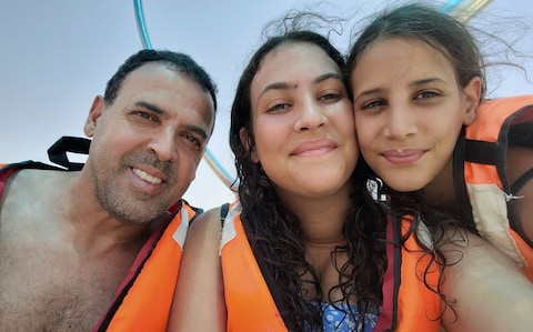 Noiya Sharabi (centre) with her sister Yahel Sharabi and father Eli 