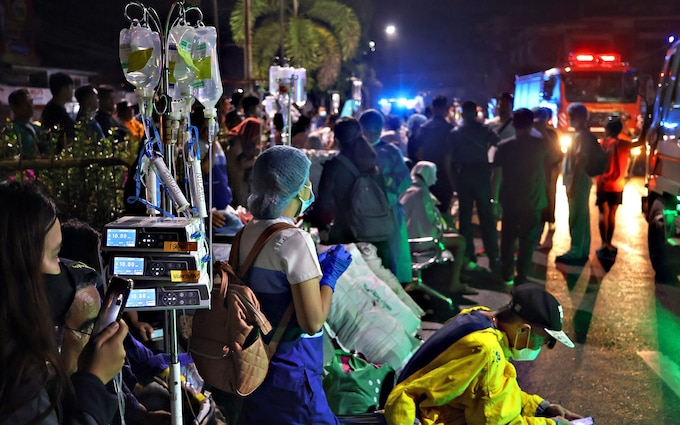Residents and medical perso<em></em>nnel evacuate patients from inside a hospital after a 7.6 earthquake struck Butuan City on the southern island of Mindanao