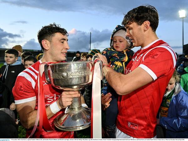 East Kerry captain Paudie Clifford, left, and brother David Clifford, and David's son Ogie, celebrate with the Bishop Moynihan Cup. Pic: Brendan Moran/Sportsfile