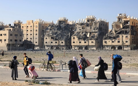 Palestinians in the city of Khan Yunis in southern Gaza flee their home