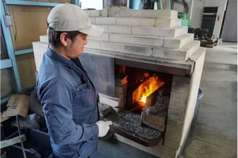 Yoshihiro Yauji, seen placing a piece of me<em></em>tal into a forge, believes 'blades are the foundatio<em></em>nal root of Japanese culture'