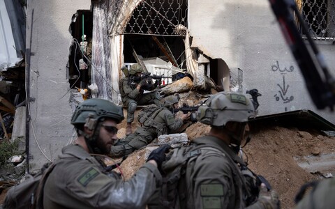 Israeli soldiers take part in a ground operation in Gaza City's Shijaiyah neighborhood, Friday, Dec. 8, 2023.