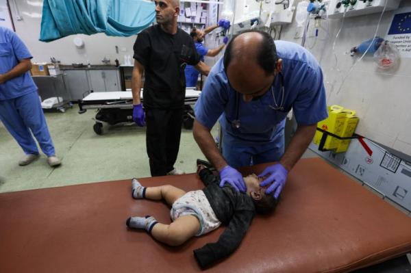 A medical worker assists a wounded Palestinian baby at Nasser hospital, following Israeli strikes, amid the o<em></em>ngoing co<em></em>nflict between Israel and the Palestinian Islamist group Hamas