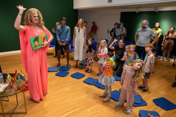  Drag Queen Pickle, left,  reads a story to children during Drag Queen Story Hour at Laguna Art Museum