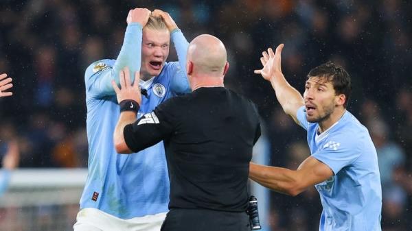 Erling Haaland (L) struggles to co<em></em>ntain his frustrations after referee Simon Hooper late decision