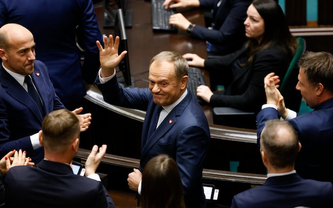 Do<em></em>nald Tusk waves to MPs at the Polish parliament in Warsaw