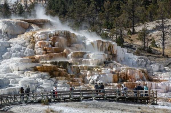 Dramatic mineral terraces along the highway are viewed near the Park Headquarters on September 21, 2022, in Mammoth Hot Springs, Yellowstone Natio<em></em>nal Park, Wyoming. Sitting atop an active volcanic caldera, Yellowstone, America's first Natio<em></em>nal Park celebrating its 150th Anniversary, is home to more geological hydrothermal features (geysers, mud pots, hot springs, fumaroles) than are found in the rest of the world combined
