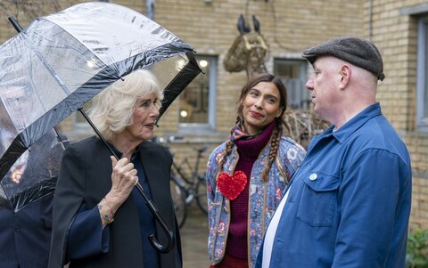 The Queen meets Syban Velardi-laufer (centre), a costume designer, and Jon Rees, who painted a wall mural, during a visit to Kindred Studios
