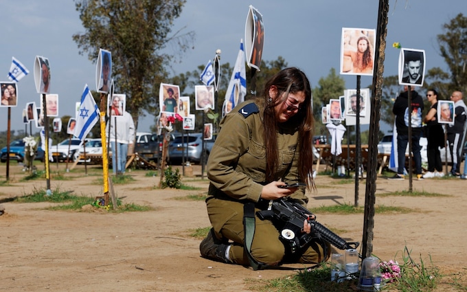 A woman reacts at the site of the Nova festival, wher<em></em>e people were killed and kidnapped 