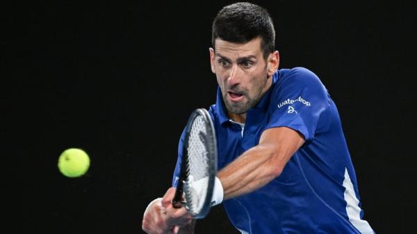 Novak Djokovic hits a return against Argentina's Tomas Etcheverry