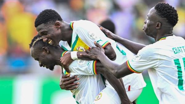 Lamine Camara (C) celebrates with Sadio Mane