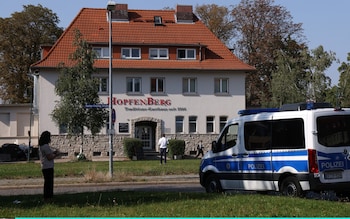 A police van stands outside the HopfenBerg restaurant, venue for the election evening party of the far-right Alternative for Germany (AfD)