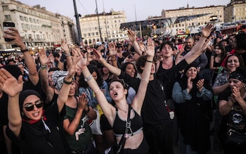 People react after the announcement of the results of the second round of the French legislative elections, in Marseille