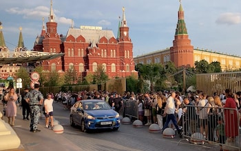 Crowds gather outside the Four Seasons Hotel hoping to get a glimpse of West