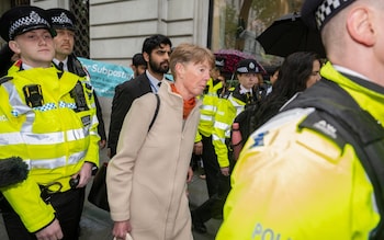Ms Vennells is surrounded by police officers in hi-vis jackets