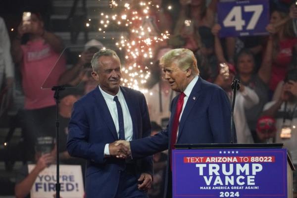 Republican presidential nominee Do<em></em>nald Trump shakes hands with former independent presidential candidate Robert F. Kennedy Jr. during a rally in Arizona.