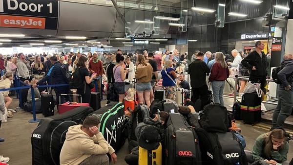 Passengers queue outside Terminal 1. Pic: Reuters