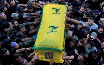 Hezbollah supporters carry the coffin of a militant killed on Saturday by an Israeli air strike