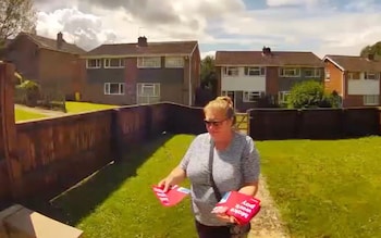 The Labour campaigner puts her leaflet through the letterbox before it is removed 