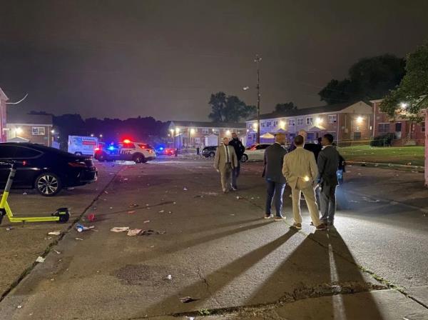 Investigators at the scene of the block party shooting