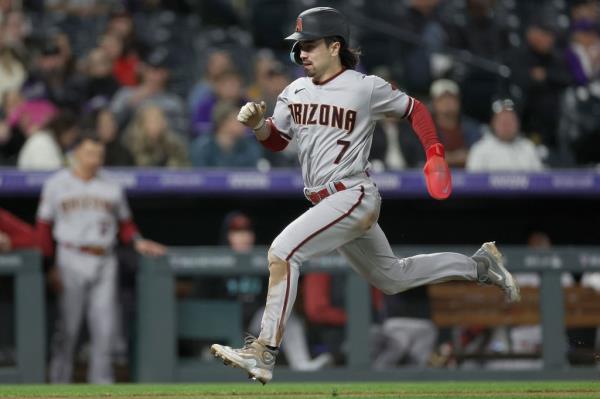 Corbin Carroll #7 of the Arizona Diamo<em></em>ndbacks scores on a Gabriel Moreno sacrifice fly against the Colorado Rockies in the seventh inning at Coors Field on April 28, 2023 in Denver, Colorado. 