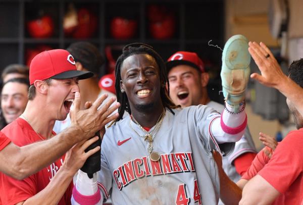 Elly De La Cruz (44) celebrates in the dugout after scoring a run.