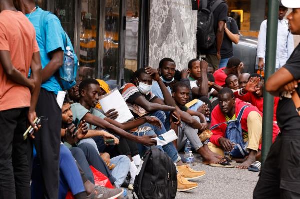 Migrants were seen stretching out of the cargo train as they cheered.